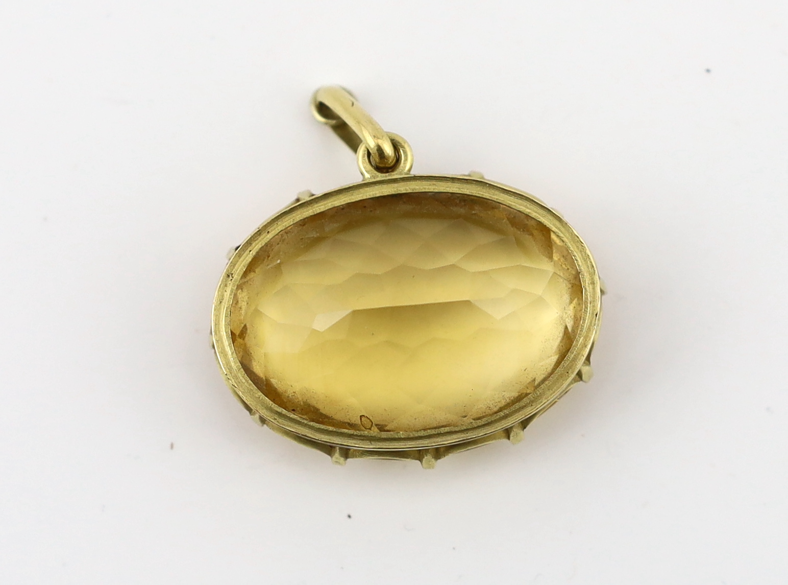 A large gold mounted oval cut citrine set pendant